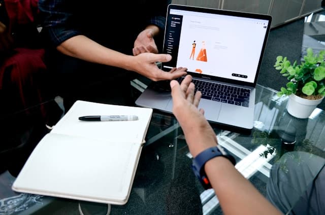 photo of laptop with hands above it.